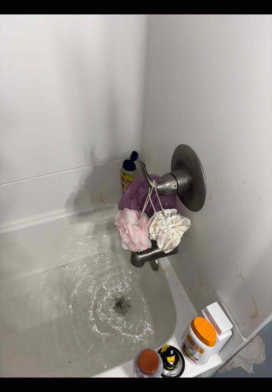 Responded to service call for first-floor bathtub leak and non-functioning sump pump. Accessed plumbing system through ceiling space below bathroom and identified source of water leak in drain assembly. Performed necessary repairs to PVC drain piping, including proper priming and fitting connections as evidenced by purple primer application at all joints. Tested bathtub for proper drainage and verified leak resolution. Sump pump issue assessed and addressed to restore functionality.