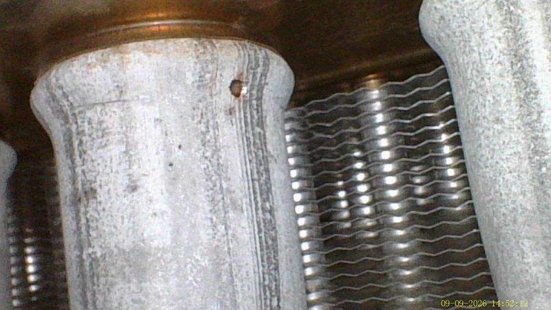 Responded to heating system concern regarding previously identified heat exchanger damage. Accessed furnace unit located in confined crawlspace for inspection. Performed visual assessment of Goodman furnace heat exchanger, documenting condition with photographs showing significant dust accumulation on burner assembly and visible heat exchanger components. Confirmed presence of compromised heat exchanger as reported during previous air conditioning installation, though no safety tag had been placed on unit. Documented findings for customer review regarding two furnace systems on property.