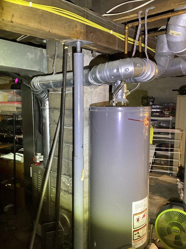 Completed annual cooling maintenance on Carrier system per 3-year tune-up agreement. Verified furnace setup switch SW1-4 (Comfort/Efficiency) was properly positioned in OFF=Efficiency mode for bypass humidifier operation, inspected HVAC equipment and water heater installation in mechanical room, and documented system configuration with photos for service records.