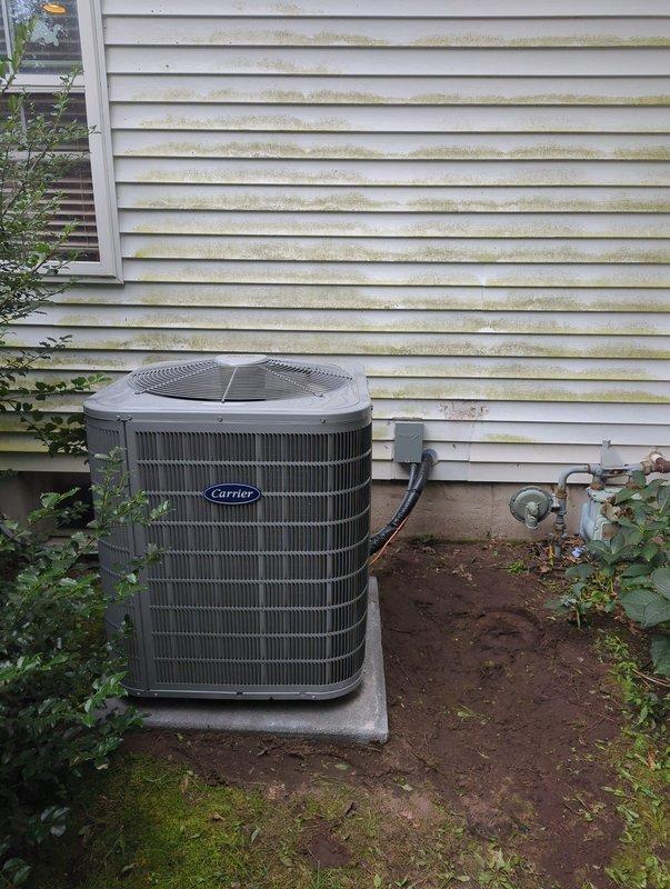 Completed full HVAC system installation including new Carrier furnace and matching outdoor condensing unit. Installed furnace in basement mechanical room with proper venting and ductwork connections, secured all refrigerant lines and electrical conduit from outdoor unit to interior equipment. Positioned outdoor AC unit on concrete pad against exterior wall with appropriate clearances, completed all electrical connections, and verified system operation upon startup.