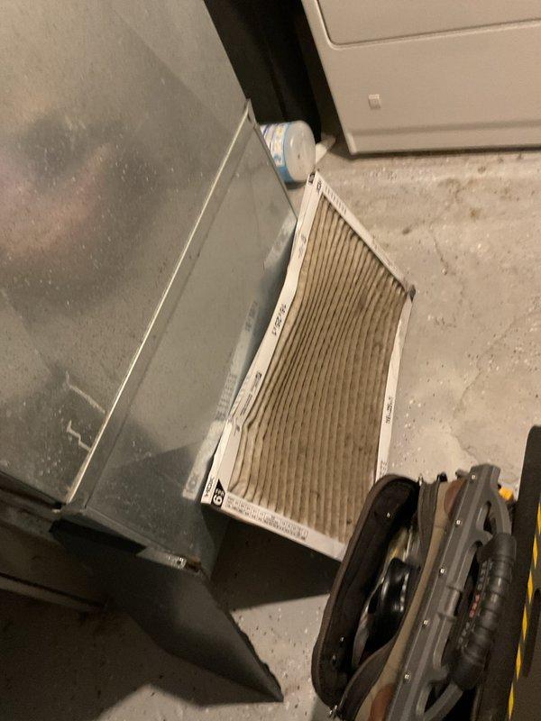 Responded to cooling complaint of unit running warm with ice buildup on a 17-year-old Goodman system. Upon inspection, found severely restricted airflow due to heavily soiled air filter clogged with dust and debris. Removed and replaced dirty filter with new unit, restoring proper airflow to the system. Verified refrigerant lines and evaporator coil access in mechanical room, allowing ice accumulation to thaw naturally with improved air circulation. System airflow restored to manufacturer specifications, resolving warm air delivery and preventing further ice formation on coil.