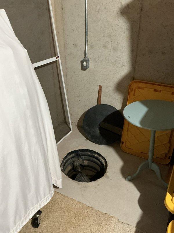 Conducted on-site assessment for plumbing project estimate in basement area. Documented existing conditions including floor drain opening with visible metal components and vertical piping configuration. Evaluated workspace accessibility and existing plumbing infrastructure beneath exposed ceiling joists to provide comprehensive project scope and material requirements for proposed plumbing installations or repairs.