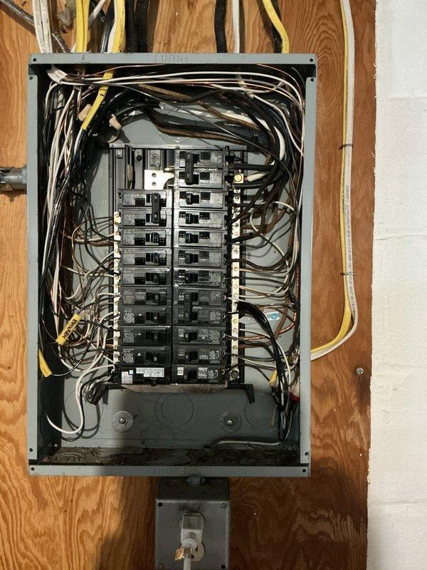 Completed comprehensive electrical club inspection of residential service panel and distribution system. Documented panel configuration showing dual-column circuit breaker arrangement with proper wire management, verified all circuit connections and conductor routing from main service entrance, and photographed panel labeling and safety compliance features for client records.