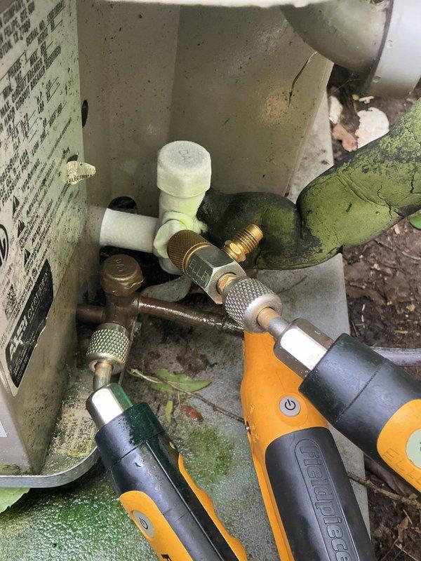 Completed annual cooling maintenance on 12-year-old Goodman system. Performed system diagnostics using digital manifold gauges at outdoor condensing unit, checked refrigerant pressures and operating temperatures, inspected service valves and refrigerant line connections. Noted significant algae growth and debris accumulation around outdoor unit requiring attention for proper airflow. Verified operation of indoor condensate pump system with proper drainage through PVC discharge line.