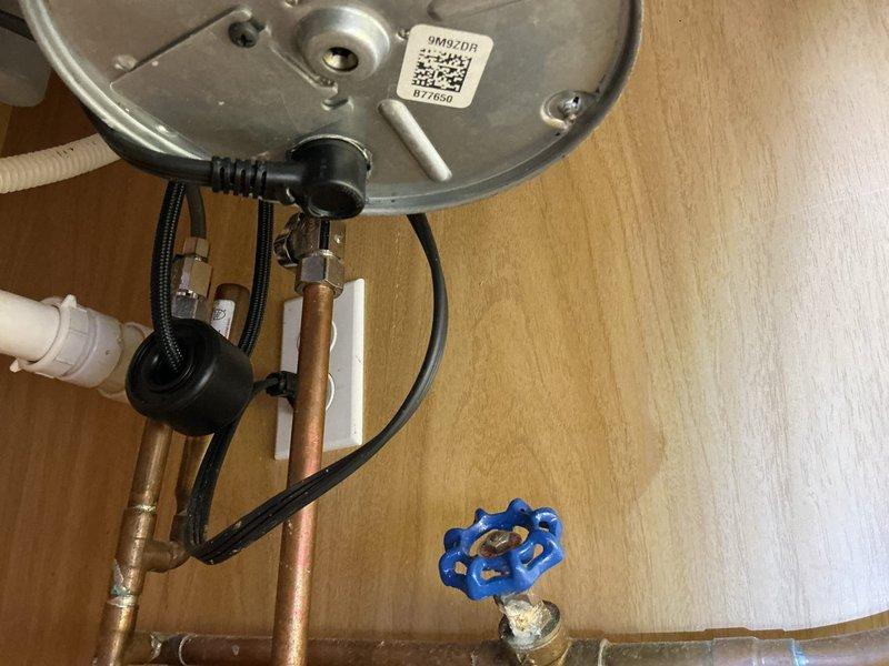 Performed camera line inspection of plumbing system using larger capacity equipment to diagnose drainage issue in water heater cabinet area. Investigation revealed significant debris accumulation beneath unit, requiring thorough documentation and assessment of waste line condition. Completed two-hour diagnostic service with photographic documentation of findings, including inspection of water heater base connections, valve assembly, and surrounding plumbing infrastructure.