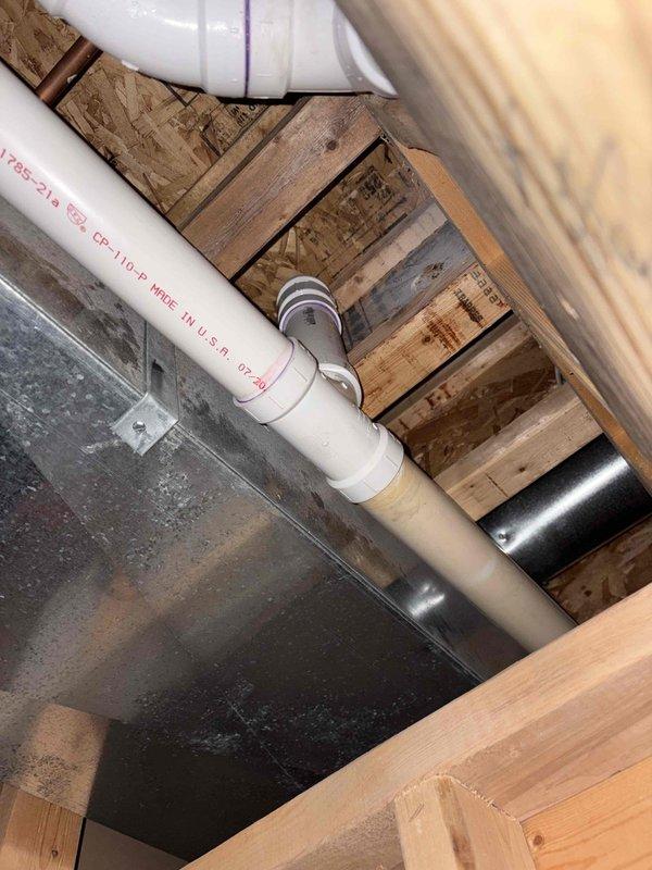 Completed repipe of sewage ejection pit discharge line, installing new PVC drainage system with proper P-trap configuration and secure connections. Replaced kitchen sink faucet assembly including supply lines and drain components, ensuring proper water flow and leak-free operation throughout the installation.