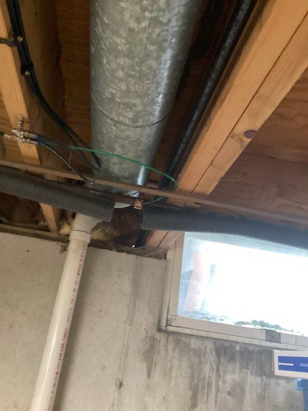Installed new gas line routing to outdoor grill location through basement utility area. Ran black iron pipe from existing gas supply, securing line to ceiling joists with appropriate hangers and brackets alongside existing ductwork and electrical conduit. Completed installation with proper valve placement and pressure testing to ensure leak-free operation and code compliance.