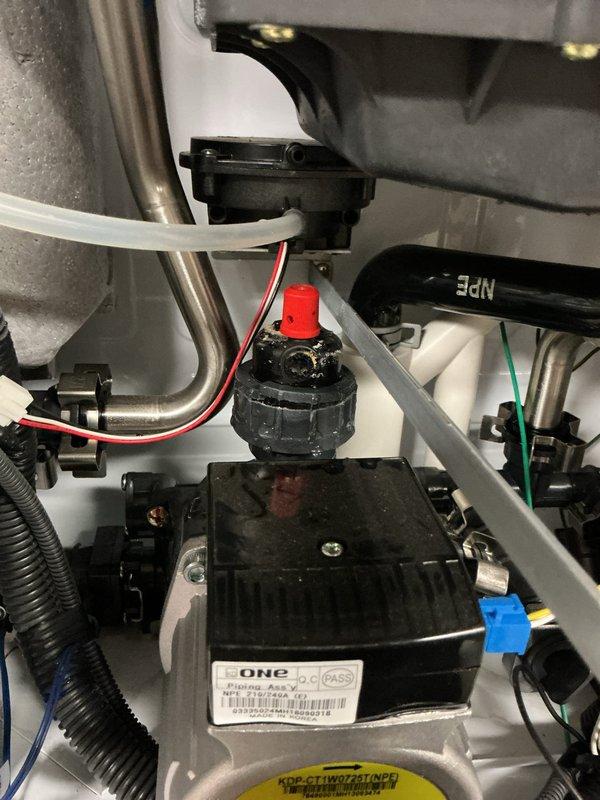 Responded to service call for leaking Navien tankless water heater approximately 6-8 years old. Upon inspection, removed front access panel and performed diagnostic assessment of internal components including circulation pump, heat exchanger assembly, water connections, and condensate drainage system. Identified source of leak and documented internal component condition with detailed photographs showing pump assembly, plumbing connections, and overall unit configuration for warranty and repair reference purposes.