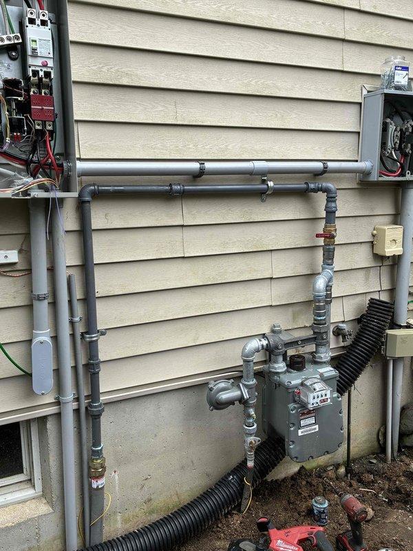 Successfully completed installation of Honeywell 18KW standby generator with 150A service upgrade. Coordinated utility disconnect/reconnect with Lansing BWL, performed complete electrical service upgrade including new transfer switch and circuit breaker panel installation, ran gas line connection to existing meter with black corrugated flexible conduit, and completed all required excavation work for proper generator pad placement and underground conduit routing. Installation passed electrical inspection and gas pressure test, with all work completed per permit requirements and manufacturer specifications.