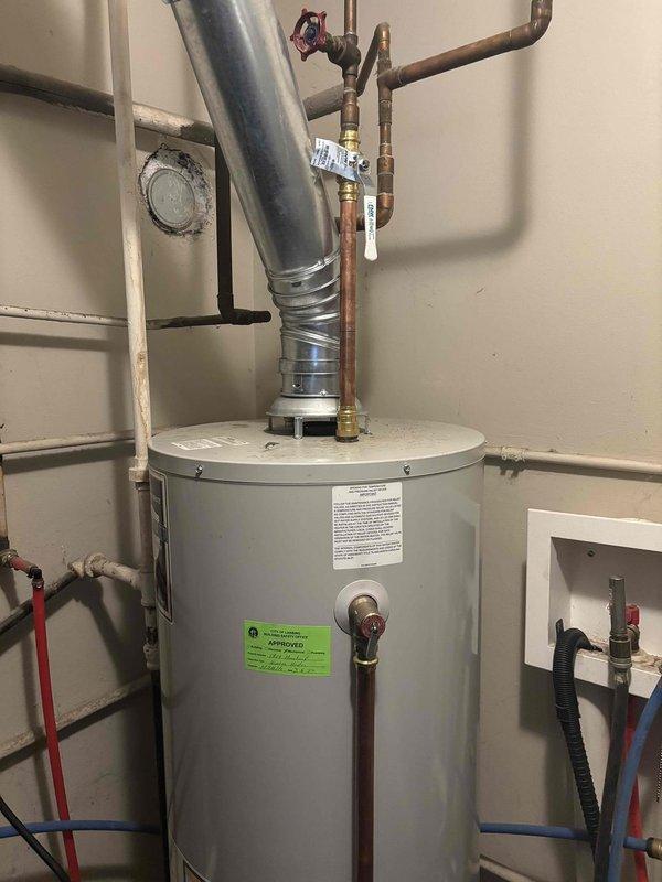Completed follow-up inspection on 4-year-old Bradford White standard tank water heater with warranty expiring 02-2028. Verified burner assembly operation and combustion chamber integrity through visual inspection of flame pattern and heat exchanger surface. Confirmed proper blue flame combustion with no signs of incomplete burning or carbon buildup. Inspected all plumbing connections, shut-off valves, and venting system for proper installation and functionality. Unit operating within normal parameters with no additional repairs required at this time.