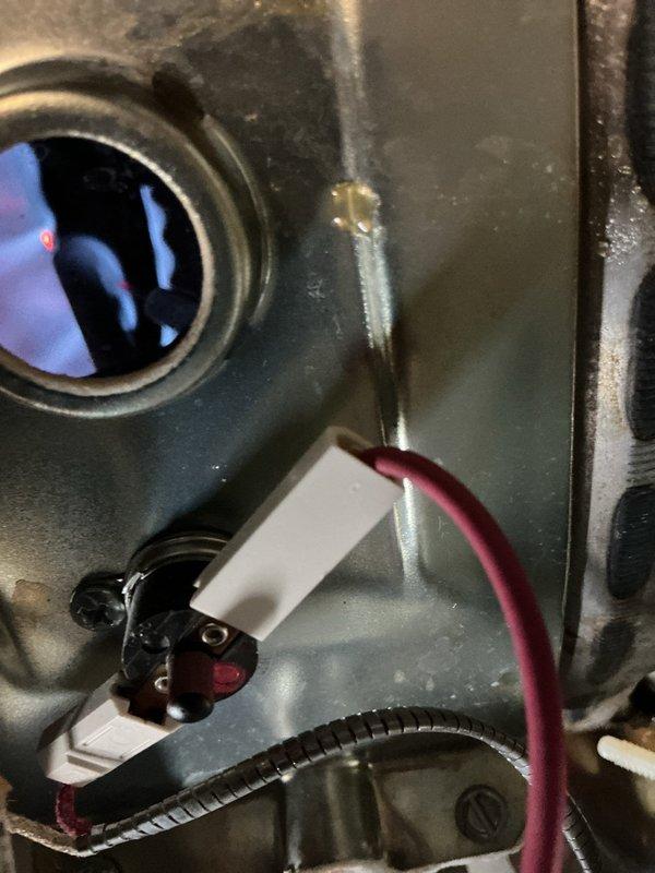 Responded to water heater pilot light issue on 5-year-old residential unit. Customer reported pilot would not stay lit after relighting, with flashing red LED indicator on gas valve control module. Inspected Honeywell gas valve assembly and burner chamber, examined flame sensor and thermocouple connections for proper seating and corrosion. Diagnosed faulty flame sensor preventing pilot safety circuit from maintaining gas flow. Cleaned flame sensor rod, verified proper grounding, and tested gas valve operation through multiple ignition cycles to confirm pilot stability and main burner function restored.