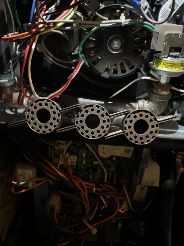Completed annual heating maintenance on furnace system per club membership agreement without humidifier service. Performed comprehensive tune-up including inspection of blower motor assembly, burner components, and gas valve operation. Verified all electrical connections, wire terminations, and safety controls functioning properly. Documented system condition with photographs showing internal mechanical components and blower assembly. Unit covered under equipment warranty extending through March 2032. All systems operational and ready for heating season.