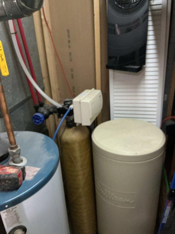 Provided estimate for tankless water heater installation to replace existing conventional tank-style water heater in basement utility area. Assessed current plumbing infrastructure including copper and galvanized steel piping, existing water treatment systems, and available space for equipment installation and venting requirements.