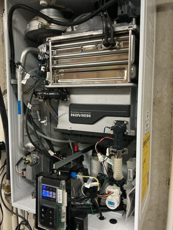 Responded to service call for Navien tankless water heater requiring air vent replacement. Upon arrival, accessed internal components by removing front panel and successfully replaced the defective air vent assembly. Unit was tested for proper operation, verified temperature display functioning at 125°F, and confirmed all venting connections were secure with no leaks detected. Closed up unit and left system in full working order.