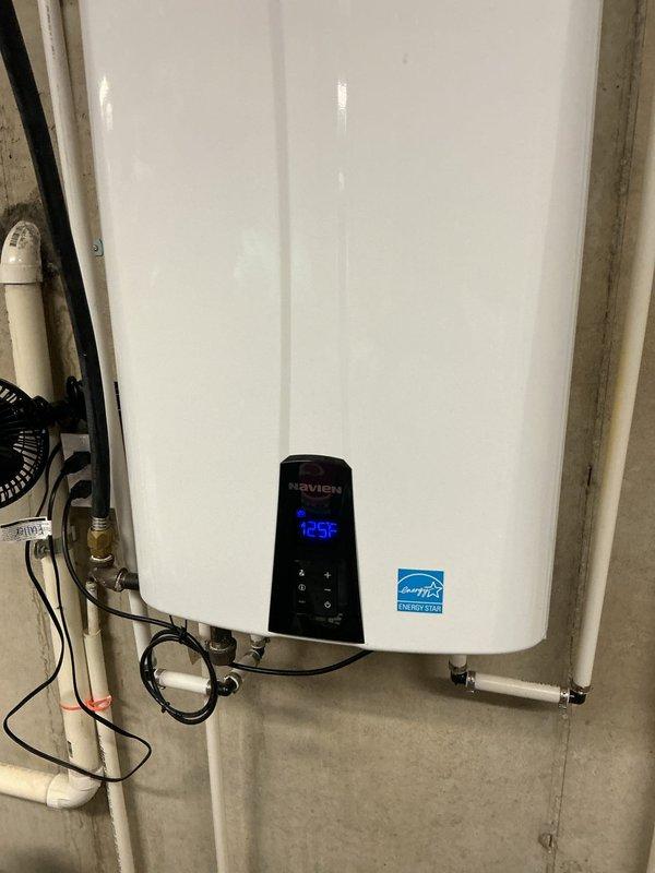 Responded to service call for Navien tankless water heater requiring air vent replacement. Upon arrival, accessed internal components by removing front panel and successfully replaced the defective air vent assembly. Unit was tested for proper operation, verified temperature display functioning at 125°F, and confirmed all venting connections were secure with no leaks detected. Closed up unit and left system in full working order.