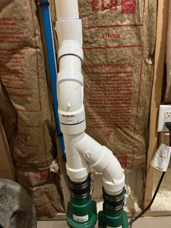 # PRSUMP-Sump Pump Problem

Responded to basement flooding complaint and performed comprehensive inspection of dual sump pump system including both primary and secondary pumps. Examined PVC discharge piping configuration, verified pump operation, and assessed plumbing installation within unfinished wall cavity. Documented existing conditions showing vertical discharge lines with multiple fittings, check valves, and electrical connections for both pump systems to determine cause of recent flooding event.