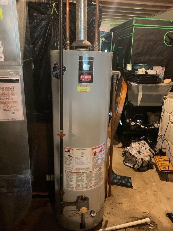 Responded to failed conventional tank-type water heater in basement utility area. Upon arrival, confirmed existing unit was inoperable with water and gas supply already shut off for safety. Conducted site assessment and documented existing installation configuration, including venting arrangement, gas line routing, and plumbing connections. Discussed tankless water heater replacement options with customer and provided estimate for conversion from conventional storage tank to on-demand tankless system, including necessary modifications to gas supply, venting, and electrical requirements for tankless operation.