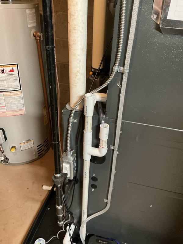 Responded to cooling issue on recently installed HVAC system experiencing excessive condensation on supply vents and cold air leaking from four duct seams. Inspected air handler and ductwork in mechanical room, identifying inadequate sealing at duct connections allowing conditioned air to escape and causing moisture accumulation on registers. Documented equipment installation including air handler unit, water heater, and associated piping systems through photographic evidence showing equipment labels, leak detection system components, and overall mechanical room layout for warranty documentation purposes.