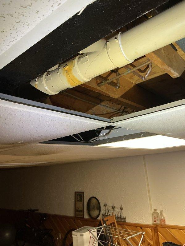 Responded to a drain-related service call that required accessing concealed plumbing infrastructure through ceiling and wall cavities. Created necessary access openings in the ceiling and interior wall to expose and address drainage system components, including ductwork and piping running through the structural framing. Successfully diagnosed and resolved the plumbing issue affecting the concealed drain lines within the building envelope.