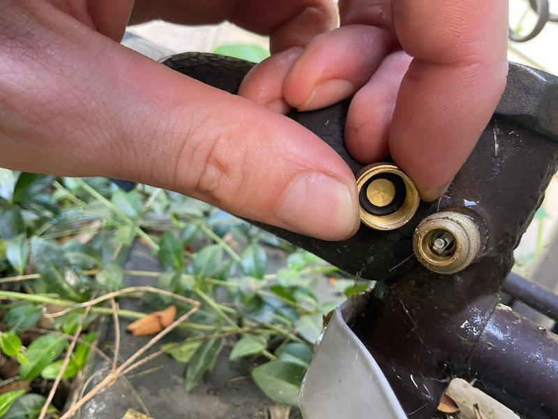 Completed annual cooling maintenance on 9-year-old Bryant air conditioning system. Inspected and cleaned brass hose connectors which showed significant accumulation of black residue and sediment buildup. Removed debris from threaded fittings and connection points to ensure proper water flow and system efficiency.