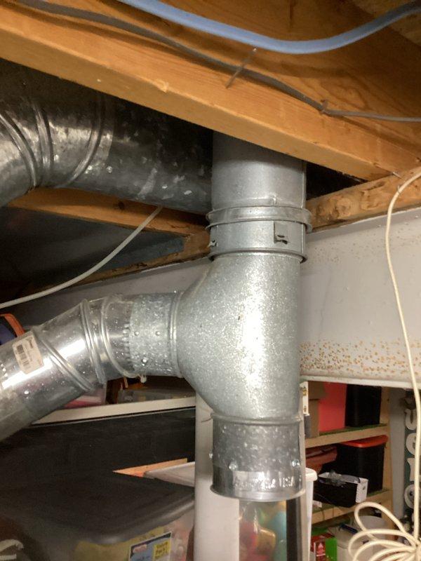 Responded to no hot water complaint on 14-year-old AO Smith water heater. Upon arrival, performed diagnostic inspection of unit and surrounding utility area. Documented existing conditions including water heater installation, associated plumbing connections with copper fittings and black PVC piping, and overhead ductwork system in basement location. Completed visual assessment and photographic documentation of equipment for service records.