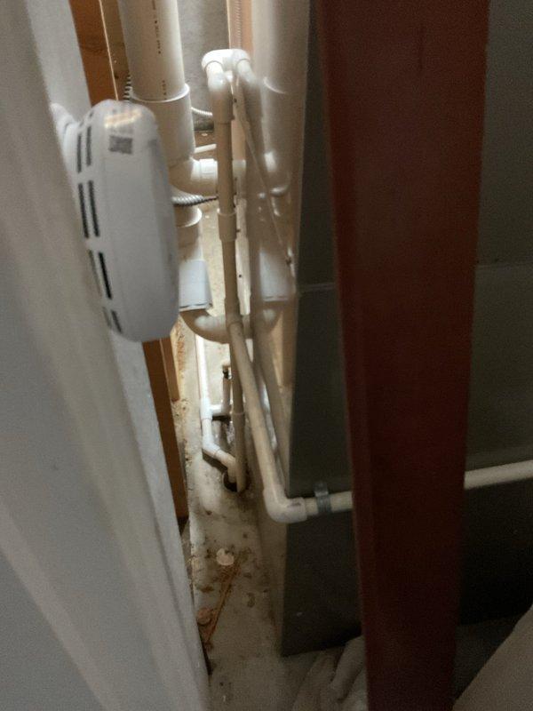 # Water Leak Service Completion

Responded to water leak concern in basement mechanical room. Upon inspection, examined HVAC air handler unit, associated ductwork, and surrounding plumbing infrastructure including copper refrigerant lines and PVC condensate drainage system. Verified all connections at condensate drain lines and fittings for proper sealing and flow. Inspected vertical copper piping and white PVC drainage components for signs of moisture, corrosion, or active leaking. Checked air handler condensate pan and drain line connections to ensure proper drainage function. Examined all visible pipe joints, fittings, and connections in the utility area for integrity. Confirmed HVAC unit operation and proper condensate removal. All plumbing connections were found secure with no active leaks detected at time of inspection. System returned to normal operation.