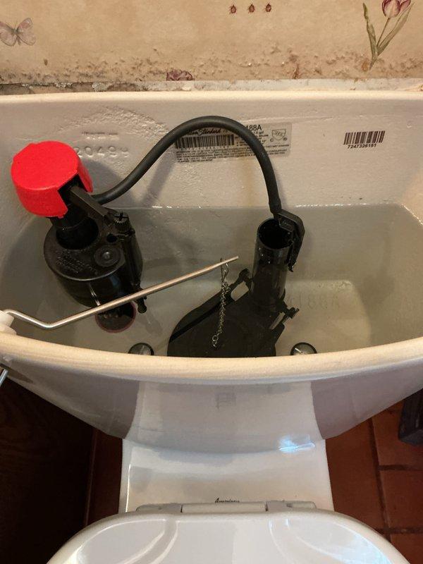 Replaced internal toilet tank components including fill valve assembly and flush mechanism. Removed tank lid, disconnected existing worn components, and installed new fill valve with proper adjustment for optimal water level. Reconnected refill tube to overflow pipe and tested flush cycle for proper operation. Verified tank refill time and water shutoff function. Cleaned tank interior and reassembled unit. Conducted final operational test to confirm leak-free performance and proper flushing action.