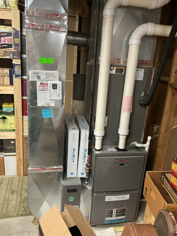 Responded to service call for leaking water heater approximately 10 years old. Upon arrival, inspected water heater unit and surrounding area, documented existing HVAC system installation including air handler and furnace components. Assessed water heater condition, identified source of leak, and photographed equipment for service records.