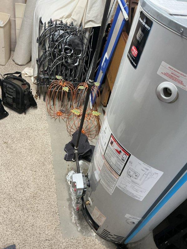Responded to service call for leaking water heater approximately 10 years old. Upon arrival, inspected water heater unit and surrounding area, documented existing HVAC system installation including air handler and furnace components. Assessed water heater condition, identified source of leak, and photographed equipment for service records.