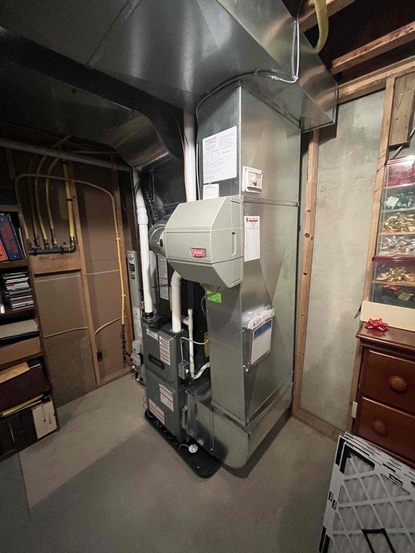 Completed full HVAC system installation in basement utility area including new furnace with humidifier attachment, air conditioning system, and Bradford White water heater. Installed all associated ductwork, copper piping, PVC condensate lines, gas connections, and flue venting per manufacturer specifications. All equipment tested and operational upon completion with digital controls programmed and verified.
