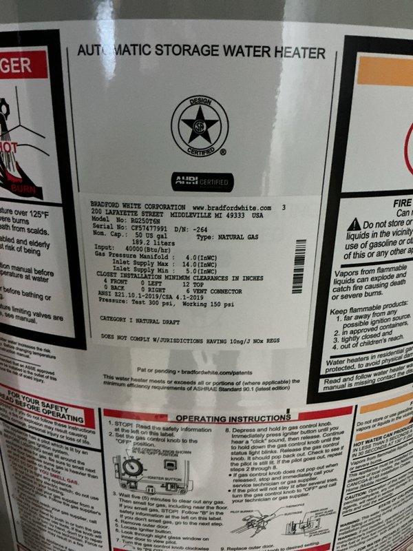 Installed a Bradford White 50-gallon natural gas water heater (model B2SU07S12N) in residential basement. Connected copper supply and distribution lines, installed black vent piping, and completed electrical connections to control panel. Unit tested and verified operational with all safety labels and specifications visible per manufacturer requirements.