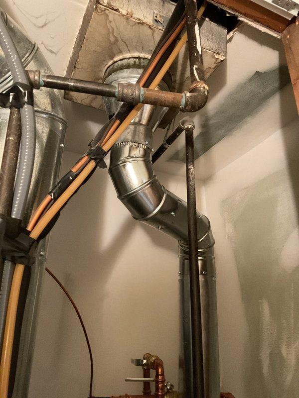 Installed a 40-gallon tall tank Bradford White natural draft natural gas water heater in basement utility room. Connected copper supply lines with shutoff valves, installed metallic exhaust flue venting system with proper draft configuration, and established all gas line connections to manufacturer specifications. Installation includes 6-year parts and 6-year labor warranty coverage.
