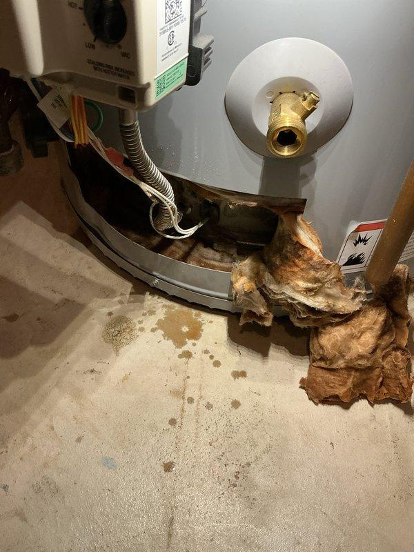 Responded to service call for leaking water heater. Upon arrival, inspected 9-year-old residential water heater and found severe corrosion and rust damage at the base of the tank with visible water leakage onto the concrete floor. The tank bottom showed extensive deterioration with rust accumulation spreading outward from the unit, indicating tank failure. Documented the condition with photographs showing the corroded base, water staining on the surrounding floor, and compromised tank integrity. Advised customer that the water heater tank has failed and requires replacement, as the corrosion damage is beyond repair and poses risk of continued leaking or catastrophic failure.