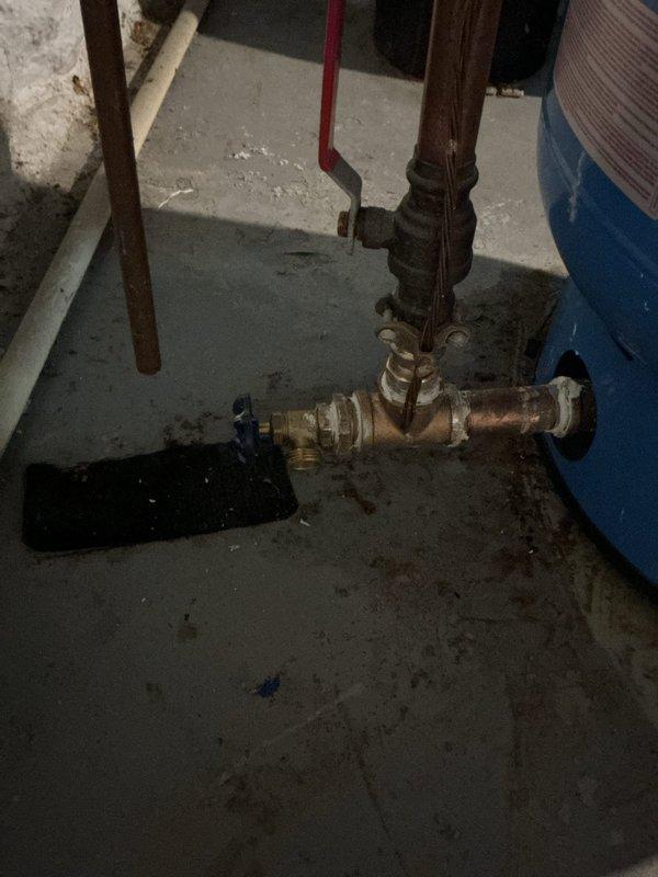 Completed QUOTR-quoted repair involving replacement of well pressure tank, pressure switch, and associated tee fittings. Removed old corroded components showing significant oxidation and wear, installed new pressure tank with proper mounting, new brass tee configuration, and new pressure switch with appropriate electrical connections. System tested and operational upon completion.