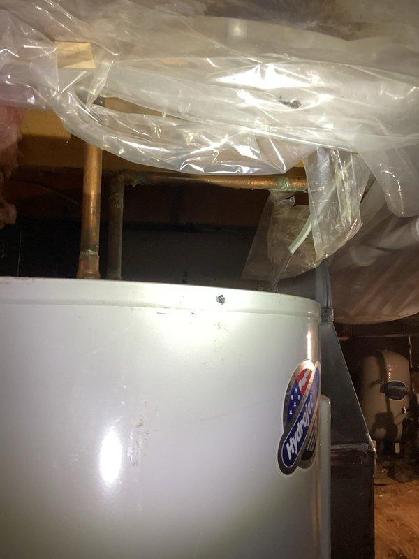 Evaluated existing Bradford White water heater in crawl space, determined unit to be approximately 10-12 years old and in need of replacement due to age. Documented current installation including copper piping connections, Carrier HVAC system proximity, and crawl space access conditions with vapor barrier present. Provided estimate for water heater replacement to customer.