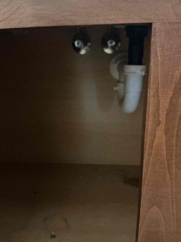 Responded to emergency water leak under bathroom sink with water spraying and inoperable shut-off valve requiring main water supply to be turned off to the home. Successfully replaced faulty shut-off valve to restore proper water control at the fixture location. Installed customer-supplied replacement faucet to address the source of the leak, tested all connections for proper operation and verified no additional leaks present in the under-sink plumbing assembly.