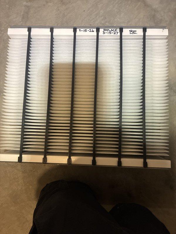Completed annual cooling maintenance on 25-year-old Carrier system. Inspected indoor and outdoor units, checked refrigerant lines and connections at condenser, documented heavily soiled air filter requiring replacement due to significant dust accumulation and discoloration. All accessible components photographed and system operational at time of service.
