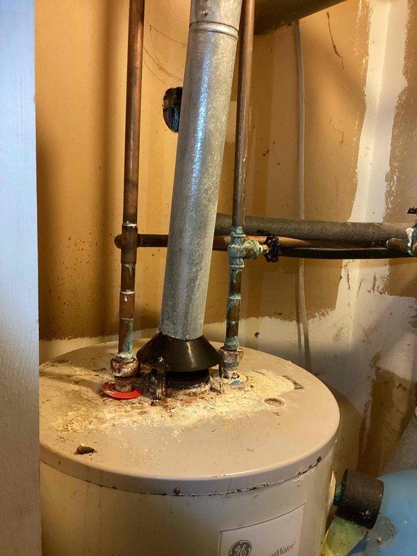 Provided estimate for replacement of 20-year-old non-functional natural gas water heater in garage. Quote includes installation of new unit with elevated positioning and accessible gas shut-off valve installation per customer request. Assessment based on existing water heater configuration with connections including copper supply lines, galvanized vent pipe, and standard gas service.