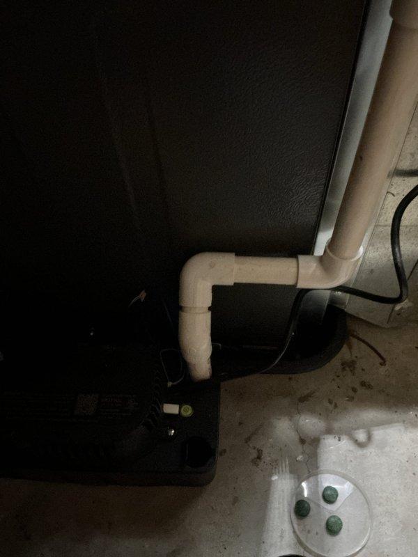 # AC Annual Cooling Maintenance Visit

Performed comprehensive annual cooling maintenance on a 7-year-old air conditioning system. Conducted thorough inspection of all interior components, revealing significant rust accumulation and corrosion on horizontal metal surfaces within the unit, along with mineral deposits and environmental debris indicating extended service exposure. Documented drainage system configuration including PVC condensate line routing through basement utility area. Verified condensate drain functionality and placement of overflow protection devices. Completed full system evaluation with photographic documentation of equipment condition for maintenance records.