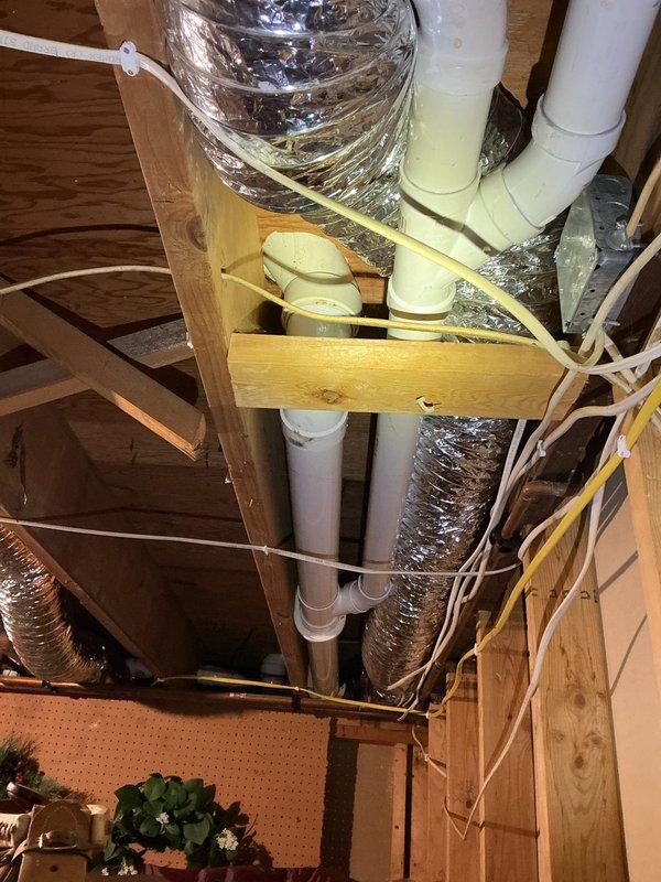 Completed project estimate for bathroom remodel involving removal of existing Jacuzzi tub and relocation of shower fixtures. Site assessment documented existing plumbing infrastructure in attic space, including PVC drain lines, HVAC ductwork routing, and structural framing that will impact new shower placement. Evaluated bathroom layout and wall configurations to determine optimal shower relocation plan and necessary rough-in modifications.