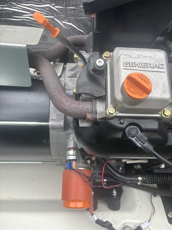 Performed comprehensive tune-up and preventive maintenance on 9-year-old Generac standby generator unit. Inspected engine components including oil fill system, dipstick, fuel lines, and electrical connections. Verified proper operation of all mechanical assemblies, checked piping connections, and examined heat exchanger components. Documented equipment condition through photographs showing engine housing, internal enclosure components, and control systems. Successfully enrolled customer in maintenance club program covering generator, furnace, air conditioning unit, and two unit heaters for ongoing service coverage.