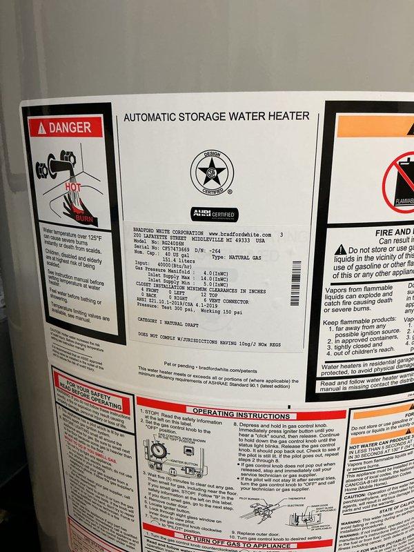 Installed a 40-gallon natural gas atmospheric vent water heater with 6-year warranty in residential utility room. Connected copper supply lines, stainless steel flue vent, and verified proper operation of all safety controls and temperature settings per manufacturer specifications.