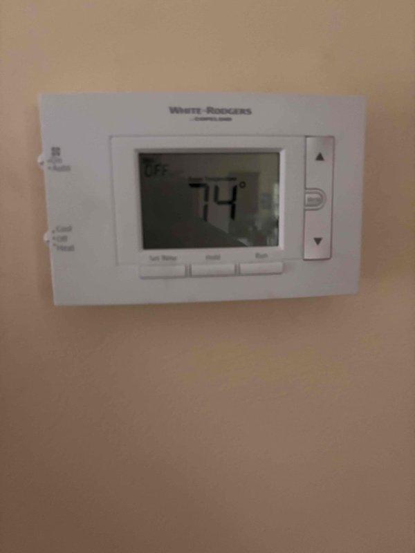Responded to customer concern regarding increased energy consumption following thermostat replacement. Inspected White-Rodgers digital thermostat installation and verified proper mounting and functionality with display reading 74°F. Examined HVAC system air filter and found heavily soiled pleated media requiring replacement, which can significantly impact system efficiency and runtime. Recommended immediate filter replacement to restore proper airflow and reduce excessive system cycling that contributes to elevated energy usage.