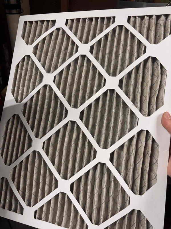 Responded to customer concern regarding increased energy consumption following thermostat replacement. Inspected White-Rodgers digital thermostat installation and verified proper mounting and functionality with display reading 74°F. Examined HVAC system air filter and found heavily soiled pleated media requiring replacement, which can significantly impact system efficiency and runtime. Recommended immediate filter replacement to restore proper airflow and reduce excessive system cycling that contributes to elevated energy usage.