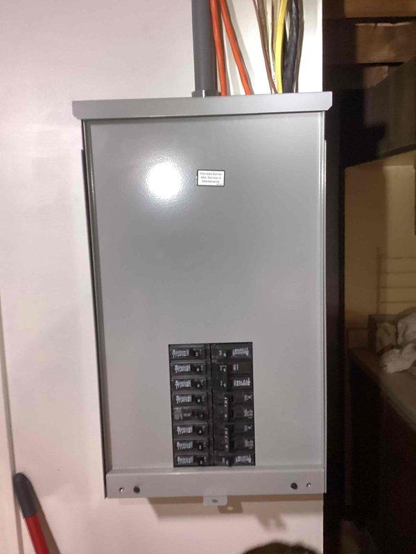 Responded to request for generator installation quote at residential property. Customer indicated existing generator inadequate for current power requirements. Conducted site assessment and documented existing electrical panel configuration, including main load center with multiple circuit breakers and associated wiring. Photographed electrical infrastructure to evaluate capacity requirements and determine appropriate generator sizing for whole-house backup power system. Captured images of interior panel installation showing current breaker arrangement and exterior panel view displaying incoming service conductors. Assessment complete for proposal preparation.