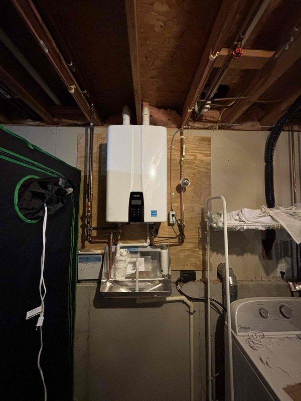 Successfully completed installation of wall-mounted tankless water heater unit in basement utility area. Unit was properly mounted to wall with secure brackets, connected to existing copper supply and return lines, and equipped with condensate drain pan for safe operation. All electrical connections were completed to manufacturer specifications, and the control panel was programmed and tested for proper functionality. System was fully commissioned, tested for proper water flow and temperature output, and confirmed operational before completion.
