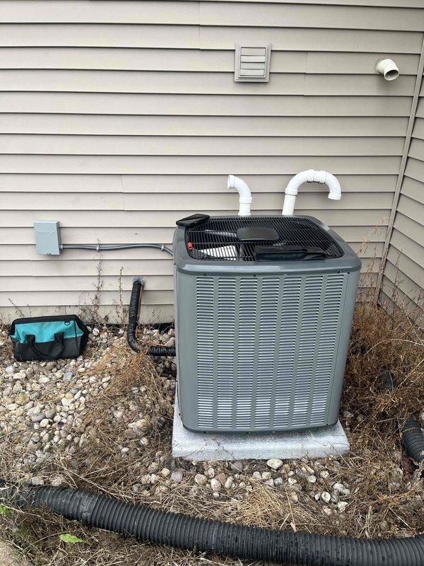 Completed full AC replacement at residential property. Removed existing air conditioning system and installed new Ruud outdoor condensing unit on concrete pad with proper electrical connections and refrigerant line sets. Installed matching indoor air handler components integrated with existing furnace system in basement mechanical room. Ran new PVC condensate drain lines from indoor unit with proper pitch and termination. Verified all electrical connections, refrigerant charge levels, and system pressures meet manufacturer specifications. Tested complete system operation including cooling cycle, airflow, and thermostat communication. All equipment properly secured, leveled, and positioned for optimal performance and serviceability.