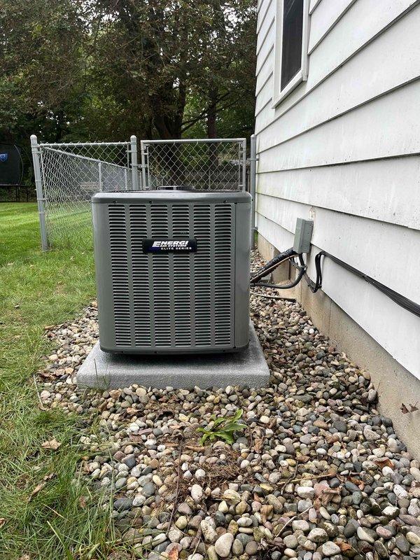 Completed full HVAC system installation including indoor air handler/furnace unit and outdoor condensing unit. Indoor equipment installed in mechanical room with proper ductwork connections, PVC condensate drainage, electrical connections, and ventilation. Outdoor condenser positioned on concrete pad with appropriate clearances, connected via electrical conduit, and surrounded by rock drainage bed for proper water management. All equipment labeled, secured, and tested for proper operation upon completion.