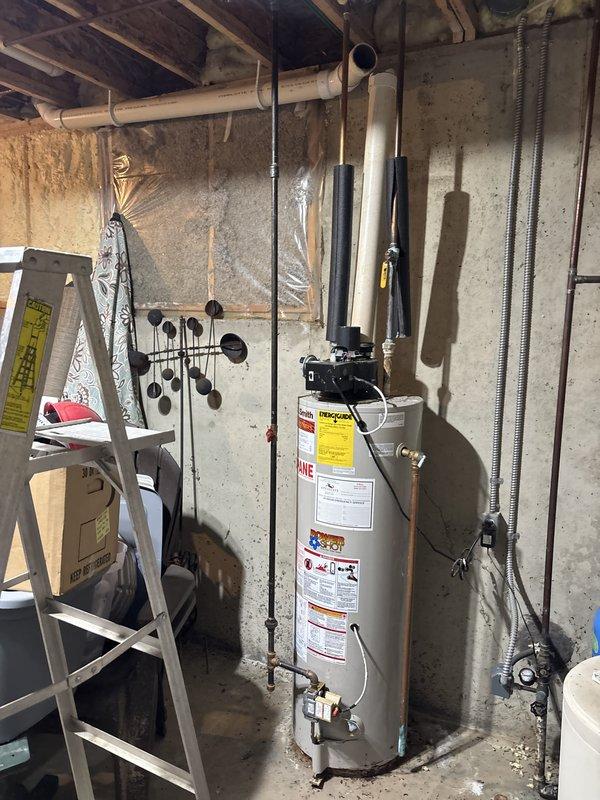 Responded to emergency service call for cracked and shattered water heater ventilation pipe with hot water shut off. Upon arrival, inspected standard tank water heater and found the top PVC vent pipe assembly had failed and required replacement. Replaced damaged ventilation piping with new PVC components, ensuring proper venting and code compliance. Tested system for proper draft and combustion safety. Additionally investigated reported squealing noise from water pump; inspected pump motor and bearings, found minor wear but unit operating within acceptable parameters. Recommended monitoring for future service needs. Restored hot water service and verified all systems functioning properly before departure. Documented conditions with photos for service records.