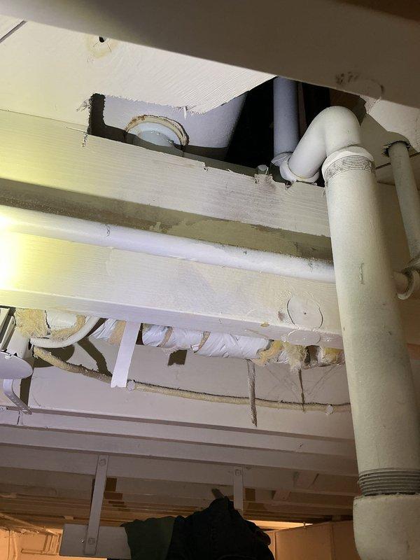 Responded to plumbing leak complaint involving pipes under sink and bathtub. Upon inspection, accessed underside of fixtures through crawlspace/basement area and identified leaking drain lines. Repaired compromised PVC waste pipe connections with new fittings and properly sealed all threaded joints. Replaced deteriorated pipe sections where necessary to ensure watertight system. Verified all connections were secure and tested drainage system to confirm leaks were eliminated. Restored access opening and left work area clean.
